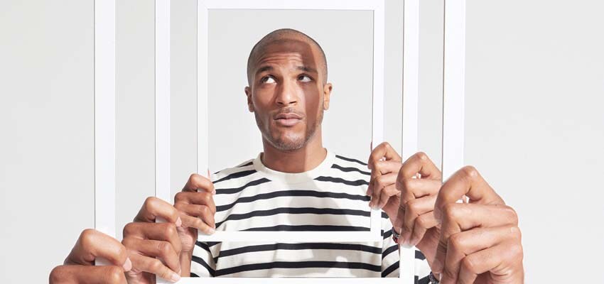 Gen Z holding empty frame in front of his face