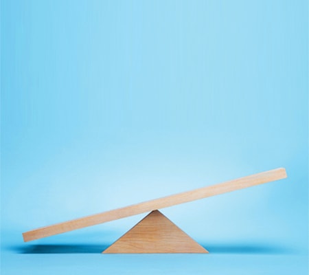 Wooden balance see-saw on a blue background