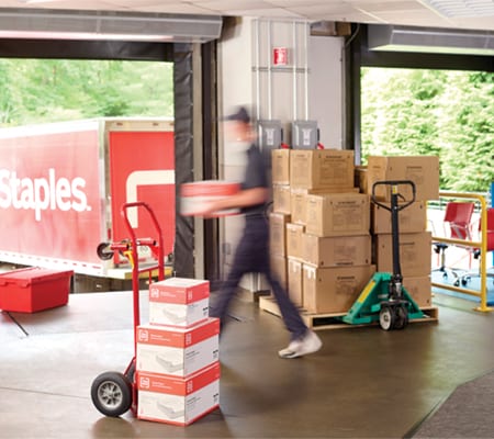 Loading doc area with boxes and a Staples truck in the background